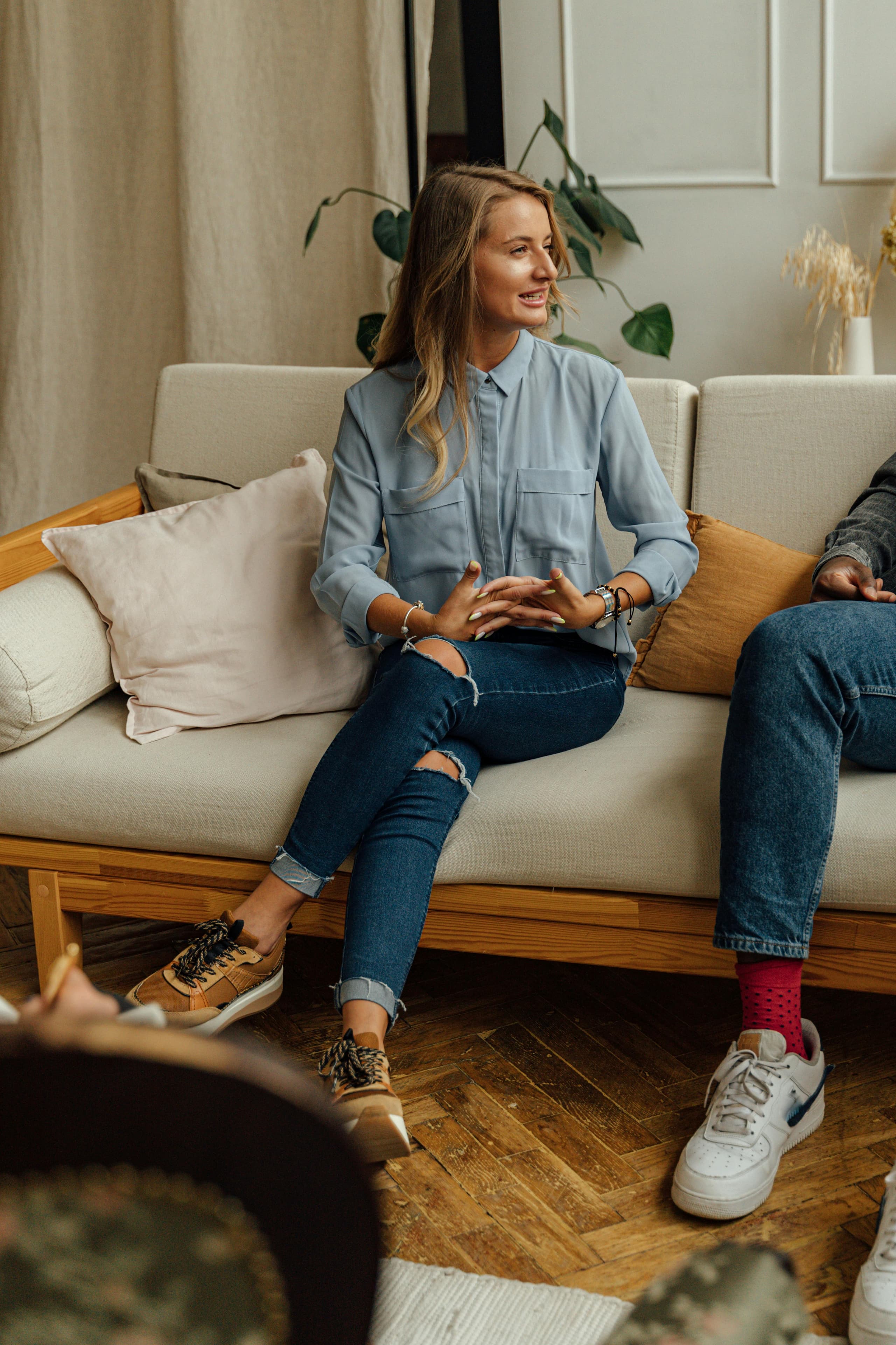 Frau auf einem Sofa im Gespräch mit einer Kollegin